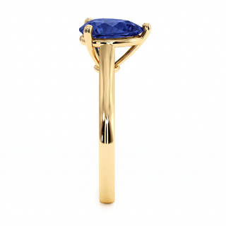 Montaigne Ring, pear-cut synthetic blue sapphire (lab-created stone), profile view, 18k yellow gold — Maison Laveran Paris