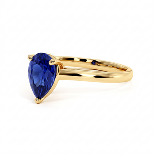 Montaigne Ring, pear-cut synthetic blue sapphire (lab-created stone), three-quarter view, 18k yellow gold — Maison Laveran Paris