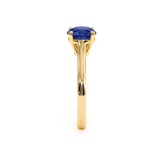 Montaigne Ring, round-cut synthetic blue sapphire (lab-created stone), profile view, 18k yellow gold — Maison Laveran Paris