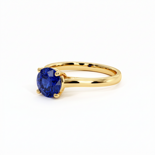 Montaigne Ring, round-cut synthetic blue sapphire (lab-created stone), three-quarter view, 18k yellow gold — Maison Laveran Paris